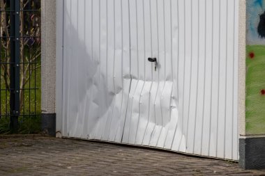 https://depositphotos.com/photo/white-damaged-garage-door-shows-accident-car-crash-drunk-driver-462200432.html